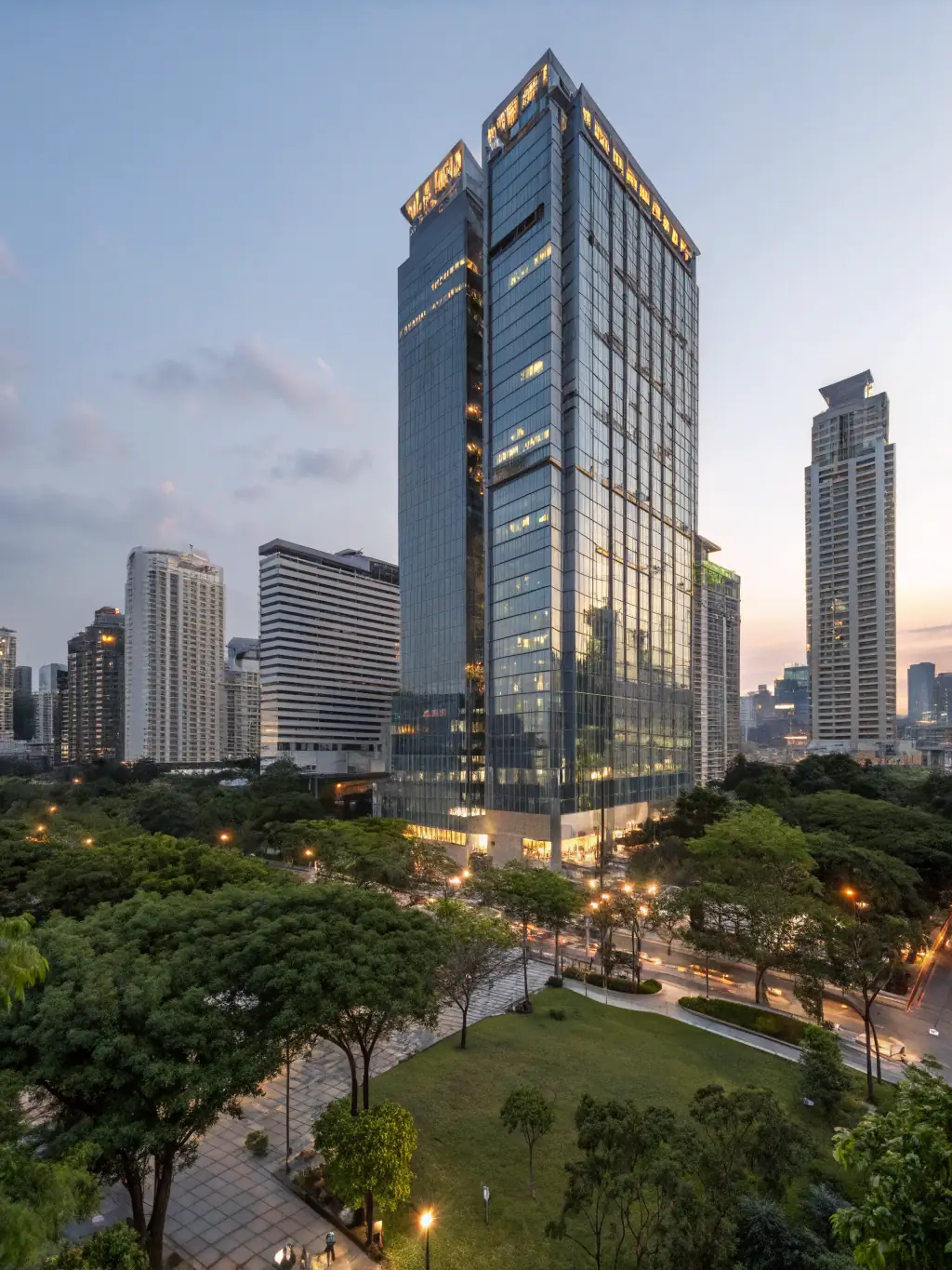 A professional photograph of a modern office building in Bangkok, Thailand, representing Max Law Firm's corporate law services. The image should convey stability and growth.